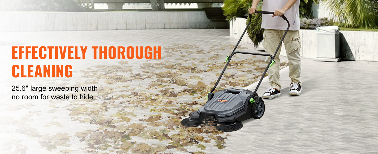man using VEVOR floor sweeper to clear leaves on a large concrete area with 25.6" sweeping width.