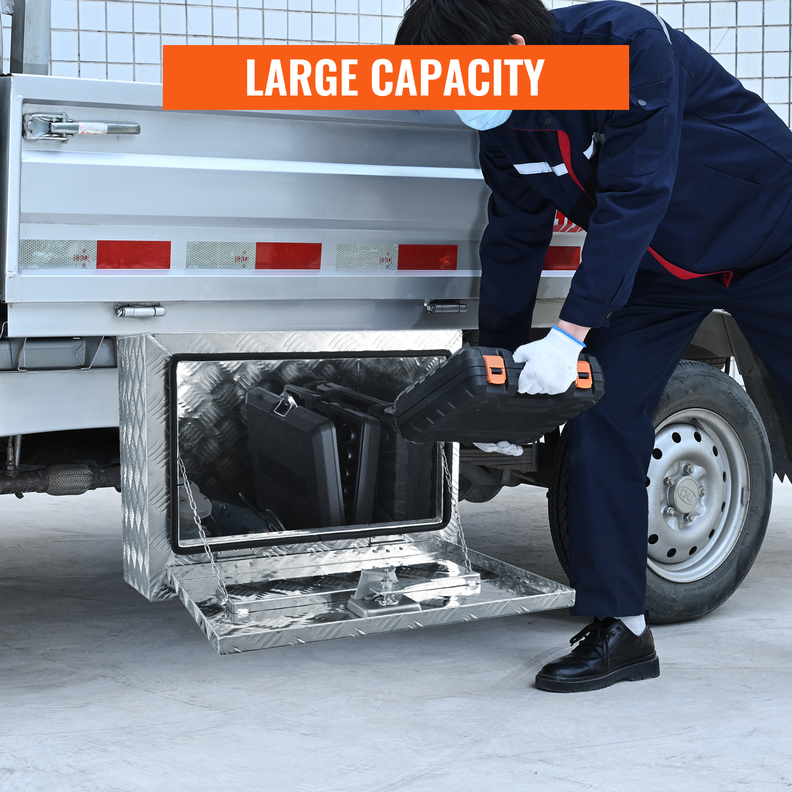 worker accessing VEVOR underbody truck box with large capacity for tool storage.