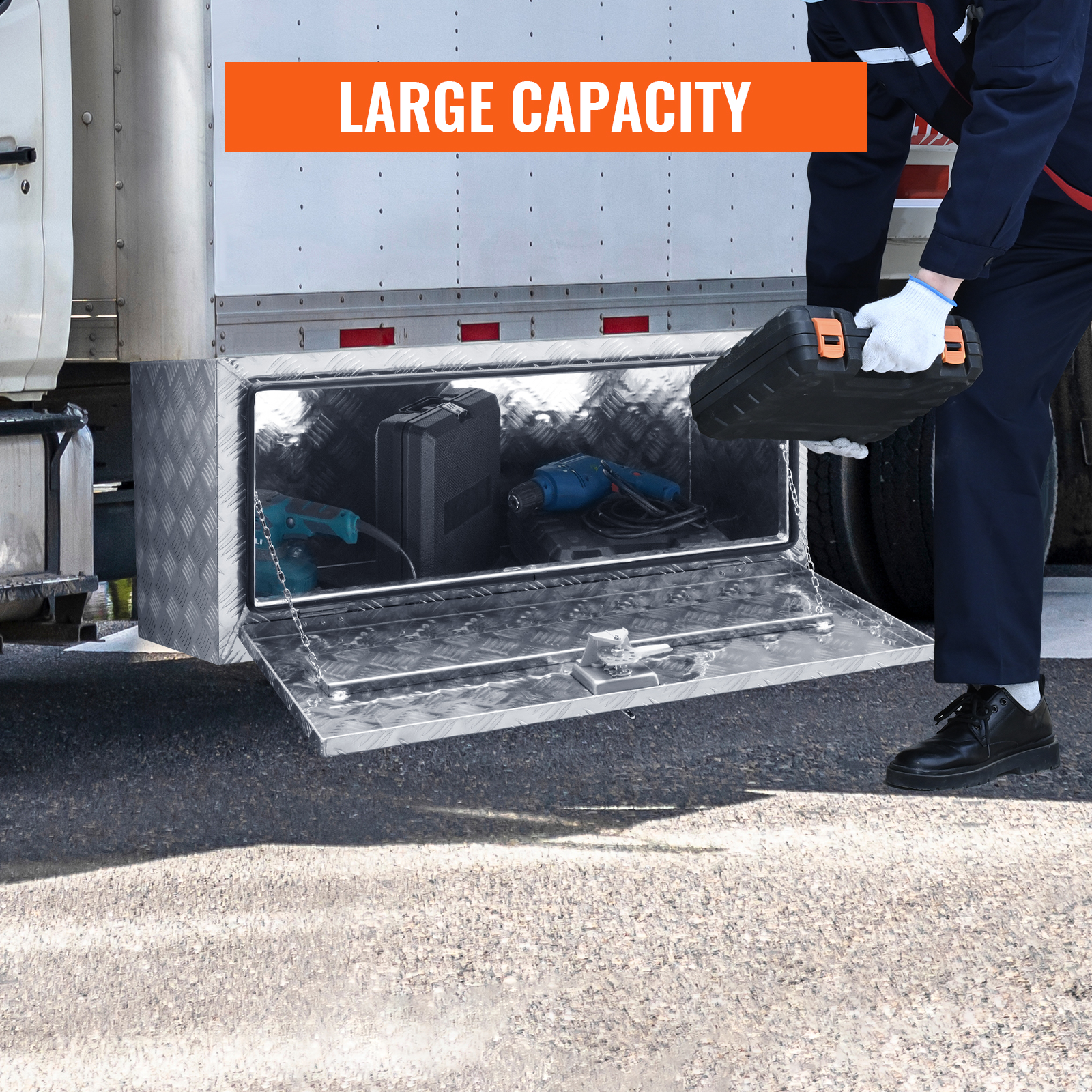 person loading tools into VEVOR underbody truck box with large capacity for secure storage.