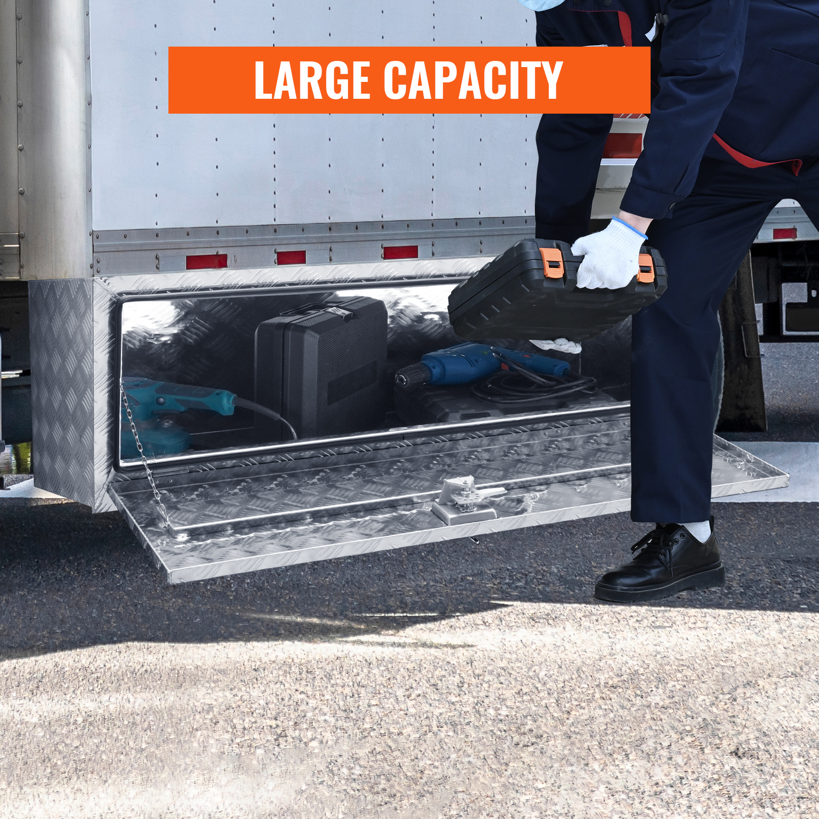 man storing tools in a large capacity VEVOR underbody truck box.