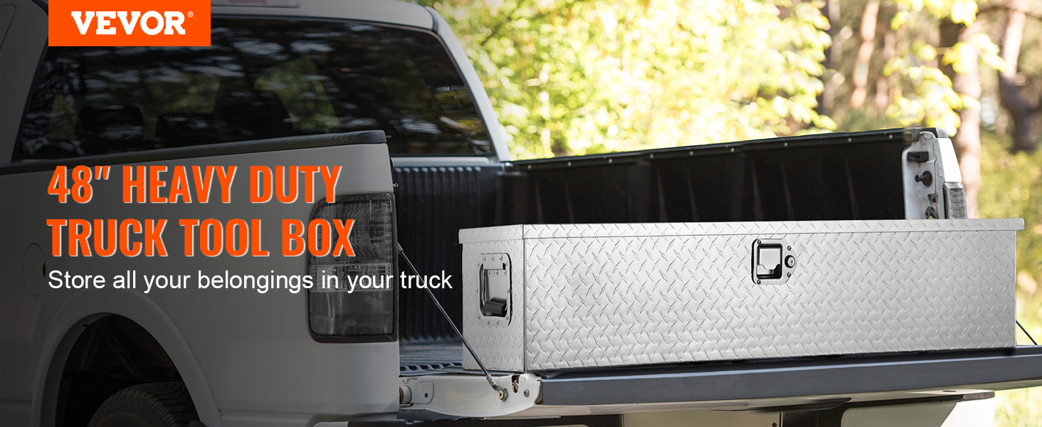 VEVOR truck bed tool box on an open truck tailgate with trees in the background.